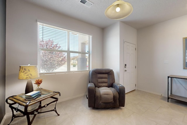 2317 Solara Loop NE, Rio Rancho, NM 87144 - living area featuring a textured ceiling and light tile patterned floors