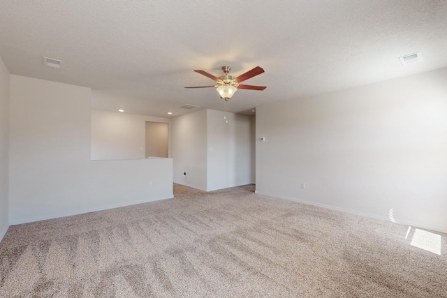 2317 Solara Loop NE, Rio Rancho, NM 87144 - unfurnished room featuring light colored carpet, ceiling fan, recessed lighting, and a textured ceiling