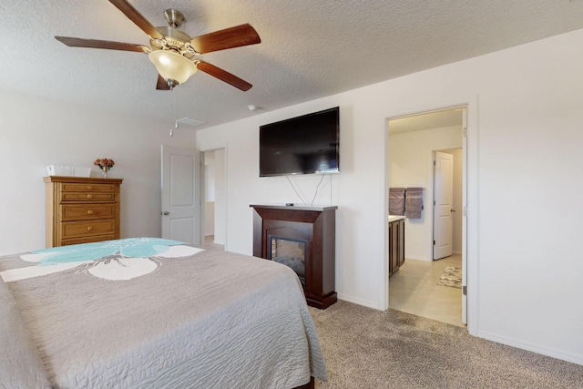 2317 Solara Loop NE, Rio Rancho, NM 87144 - bedroom with a glass covered fireplace, light colored carpet, a textured ceiling, and ceiling fan
