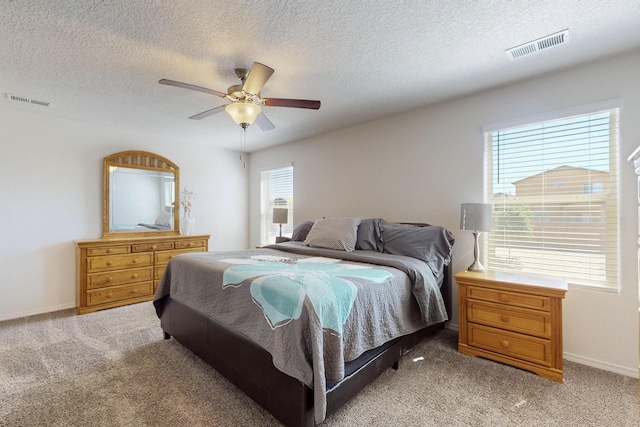 2317 Solara Loop NE, Rio Rancho, NM 87144 - bedroom with light carpet, a textured ceiling, and a ceiling fan