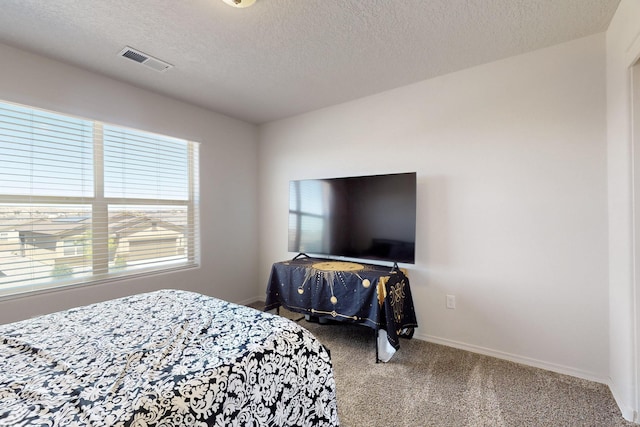 2317 Solara Loop NE, Rio Rancho, NM 87144 - carpeted bedroom with a textured ceiling and baseboards