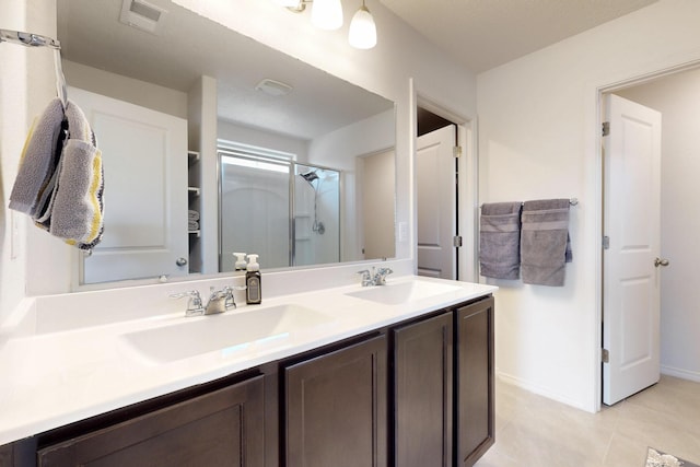 2317 Solara Loop NE, Rio Rancho, NM 87144 - bathroom featuring double vanity, a shower stall, and tile patterned flooring