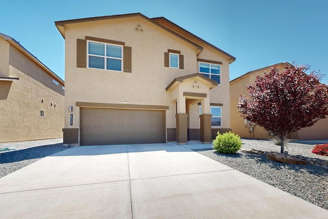 2317 Solara Loop NE, Rio Rancho, NM 87144 - view of front of property with an attached garage, stucco siding, and driveway