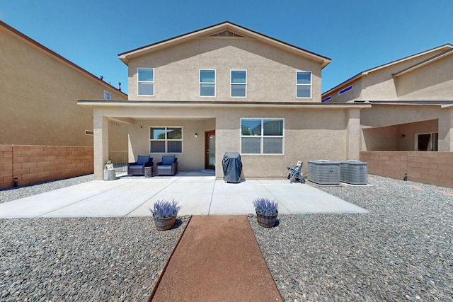 2317 Solara Loop NE, Rio Rancho, NM 87144 - rear view of house featuring a patio, stucco siding, and an outdoor hangout area