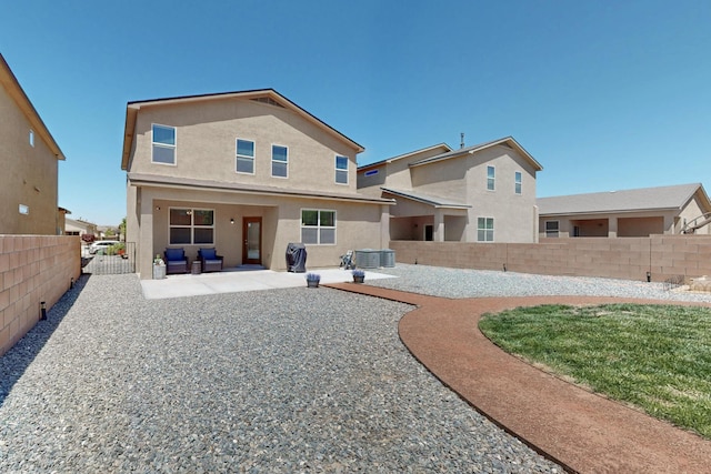 2317 Solara Loop NE, Rio Rancho, NM 87144 - rear view of house featuring a patio area, stucco siding, and a fenced backyard