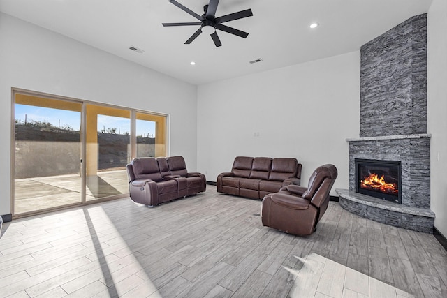 11 Del Cerro Ct, Los Lunas, NM 87031 - living room with a ceiling fan, wood finished floors, a stone fireplace, and recessed lighting