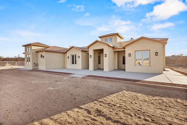 11 Del Cerro Ct, Los Lunas, NM 87031 - view of front of property featuring a patio, stucco siding, and metal roof