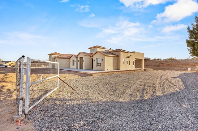 11 Del Cerro Ct, Los Lunas, NM 87031 - view of front facade with stucco siding and a patio