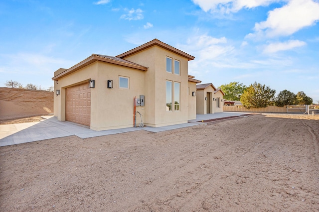 11 Del Cerro Ct, Los Lunas, NM 87031 - view of front of property with concrete driveway, an attached garage, and stucco siding