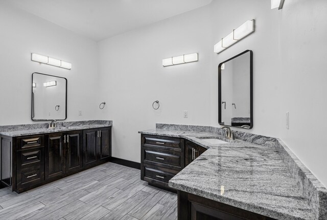 11 Del Cerro Ct, Los Lunas, NM 87031 - full bath with two vanities, wood finished floors, and baseboards