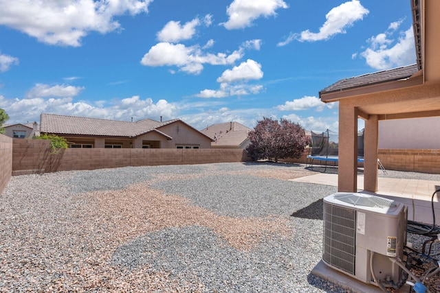 8331 Wild Dunes Ave NW, Albuquerque, NM 87120 - fenced backyard with a trampoline, central AC unit, and a patio
