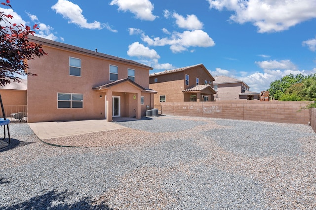 8331 Wild Dunes Ave NW, Albuquerque, NM 87120 - back of house featuring a patio, a fenced backyard, stucco siding, and cooling unit