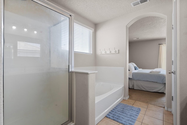8331 Wild Dunes Ave NW, Albuquerque, NM 87120 - ensuite bathroom featuring a shower stall, a bath, a textured ceiling, and tile patterned flooring