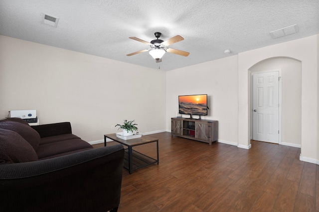 8331 Wild Dunes Ave NW, Albuquerque, NM 87120 - living area featuring dark wood-style flooring, ceiling fan, baseboards, and a textured ceiling