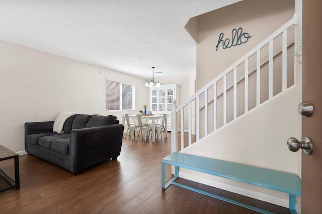 8331 Wild Dunes Ave NW, Albuquerque, NM 87120 - living room with a chandelier, a textured ceiling, dark wood finished floors, stairway, and baseboards