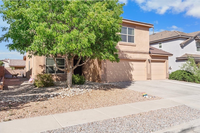8331 Wild Dunes Ave NW, Albuquerque, NM 87120 - obstructed view of property with concrete driveway, stucco siding, and a garage