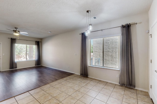 9624 Basalt Peak Dr NW, Albuquerque, NM 87114 - empty room with a ceiling fan, a textured ceiling, baseboards, and light wood-type flooring