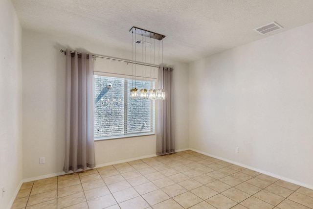 9624 Basalt Peak Dr NW, Albuquerque, NM 87114 - unfurnished room with a textured ceiling, a chandelier, and light tile patterned floors