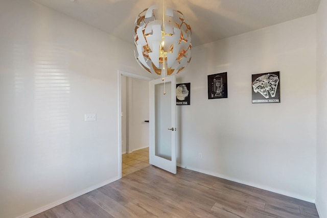 9624 Basalt Peak Dr NW, Albuquerque, NM 87114 - unfurnished room featuring wood finished floors, baseboards, and a chandelier