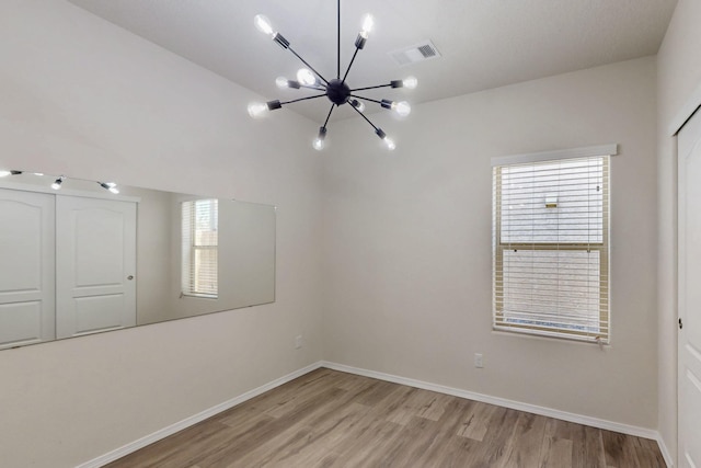 9624 Basalt Peak Dr NW, Albuquerque, NM 87114 - unfurnished room featuring a chandelier, light wood-style flooring, healthy amount of natural light, and baseboards