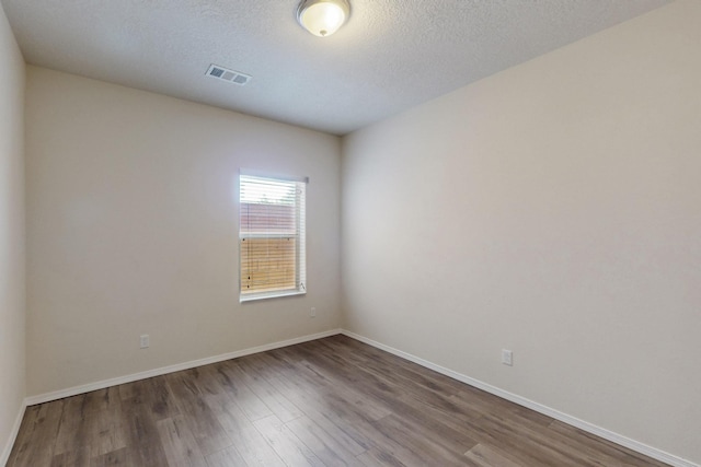 9624 Basalt Peak Dr NW, Albuquerque, NM 87114 - unfurnished room featuring wood finished floors, baseboards, and a textured ceiling