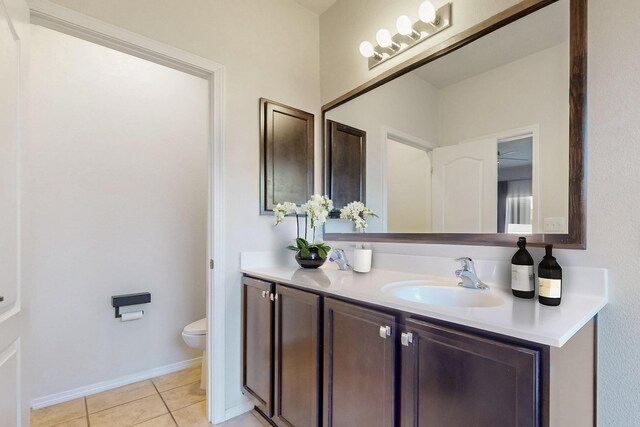 9624 Basalt Peak Dr NW, Albuquerque, NM 87114 - bathroom featuring toilet, tile patterned floors, vanity, and baseboards