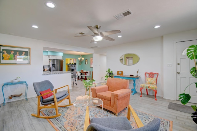 10008 Propps St NE, Albuquerque, NM 87112 - living area with ceiling fan, light wood-style flooring, recessed lighting, baseboards, and a chandelier