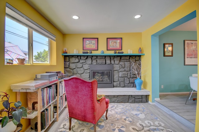 10008 Propps St NE, Albuquerque, NM 87112 - sitting room featuring a stone fireplace, recessed lighting, wood finished floors, and baseboards