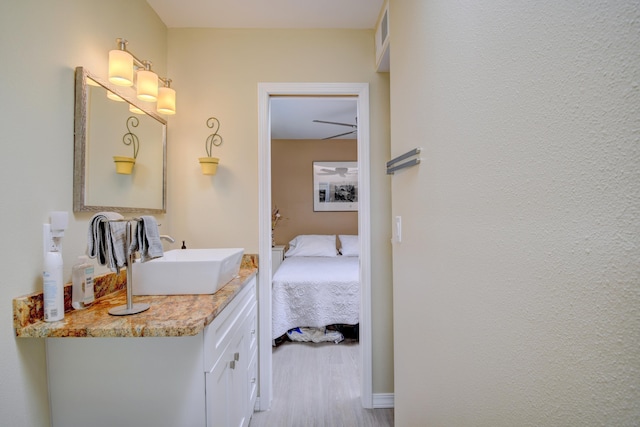 10008 Propps St NE, Albuquerque, NM 87112 - bathroom featuring vanity, connected bathroom, and wood finished floors