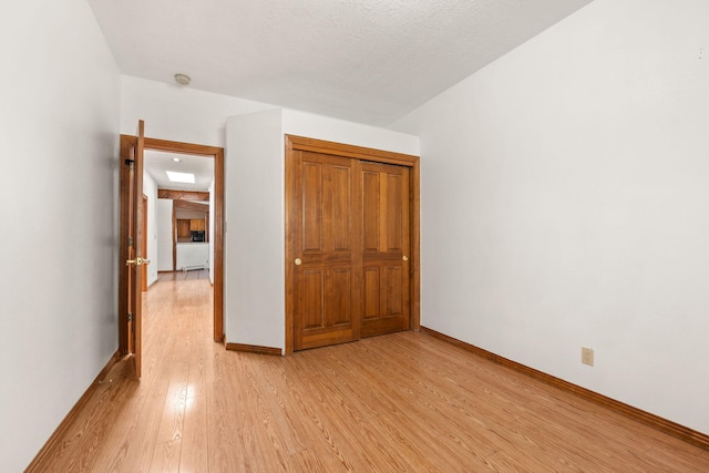 6116 Agate Ave NW, Albuquerque, NM 87120 - unfurnished bedroom featuring light wood-style flooring and baseboards