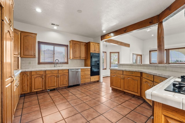 6116 Agate Ave NW, Albuquerque, NM 87120 - kitchen with dishwasher, a sink, backsplash, tile countertops, and recessed lighting