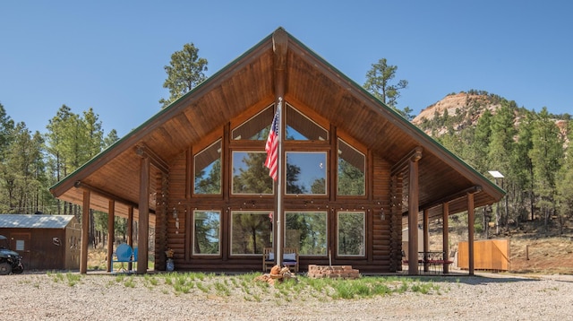 31 Smokey Bear Rd, Ramah, NM 87321 - view of side of property with log siding and a mountain view