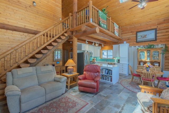 31 Smokey Bear Rd, Ramah, NM 87321 - living area with a high ceiling, stairs, rustic walls, ceiling fan, and stone finish floors