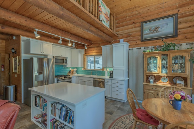 31 Smokey Bear Rd, Ramah, NM 87321 - kitchen with stainless steel appliances, a sink, wooden ceiling with exposed beams, light countertops, and a center island