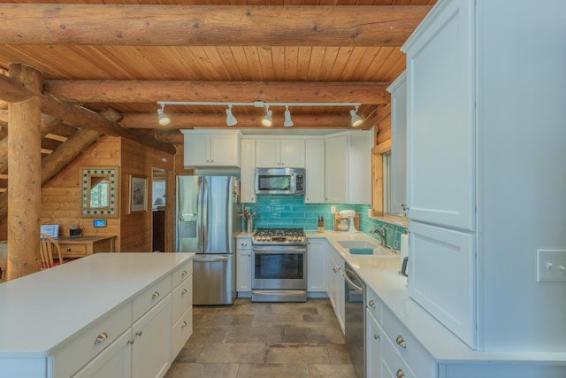 31 Smokey Bear Rd, Ramah, NM 87321 - kitchen featuring stainless steel appliances, wood ceiling with exposed beams, a sink, light countertops, and white cabinetry