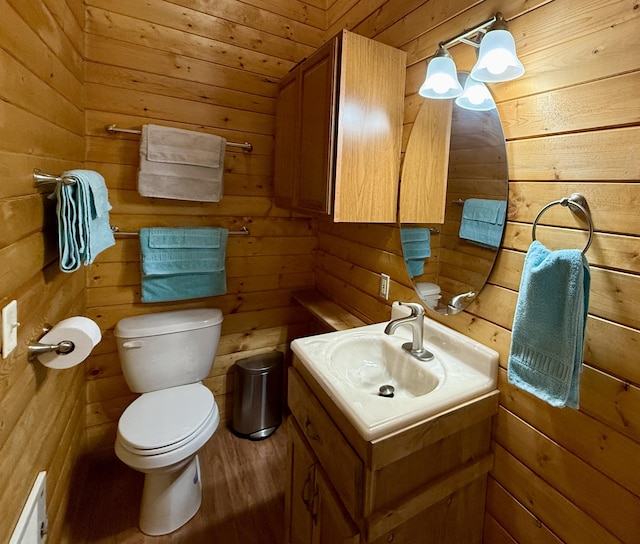 31 Smokey Bear Rd, Ramah, NM 87321 - bathroom featuring wood walls, toilet, vanity, and wood finished floors