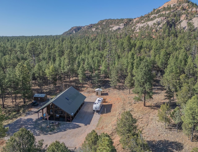 31 Smokey Bear Rd, Ramah, NM 87321 - aerial view of property and surrounding area featuring a heavily wooded area and a mountainous background