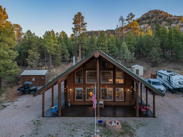 31 Smokey Bear Rd, Ramah, NM 87321 - rear view of property featuring a forest view, an outdoor structure, log veneer siding, and a mountain view