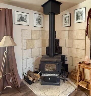 34 Halcon Rd, Ramah, NM 87321 - detailed view of a wood stove and wood finished floors