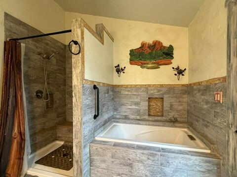 34 Halcon Rd, Ramah, NM 87321 - bathroom with a bath and tiled shower