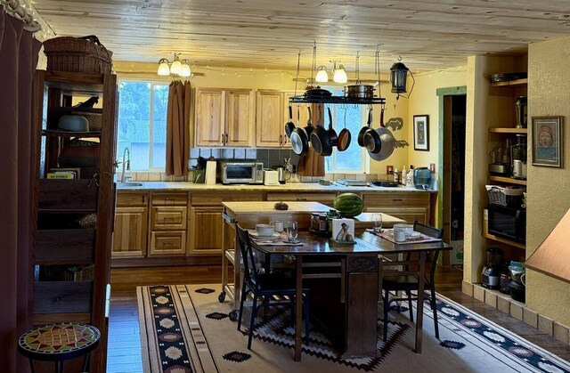 34 Halcon Rd, Ramah, NM 87321 - kitchen featuring light countertops, dark wood-style flooring, plenty of natural light, wood ceiling, and a sink
