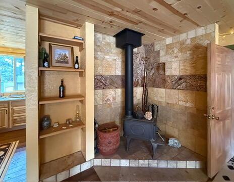 34 Halcon Rd, Ramah, NM 87321 - detailed view of a wood stove and built in shelves