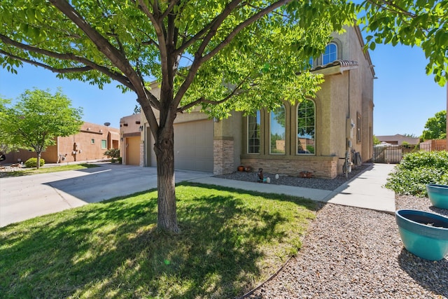 2115 Cortina Loop SE, Rio Rancho, NM 87124 - view of front of house with stucco siding, driveway, and a garage