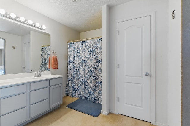 2115 Cortina Loop SE, Rio Rancho, NM 87124 - bathroom with double vanity, a textured ceiling, and a shower with curtain