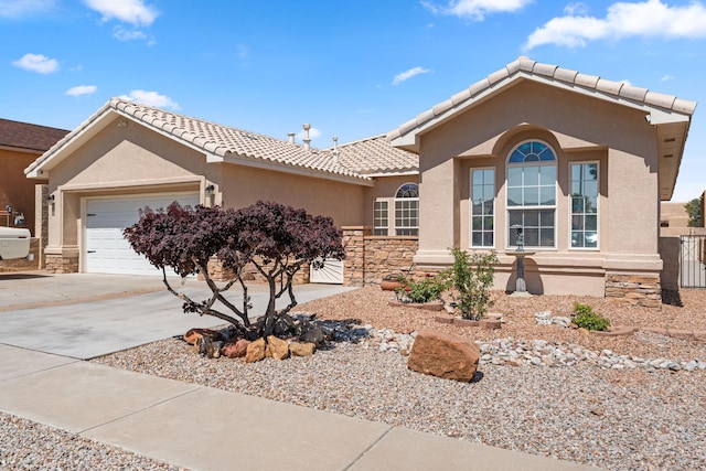 1908 Selway Pl NW, Albuquerque, NM 87120 - view of front facade featuring stucco siding, a garage, driveway, a tile roof, and stone siding