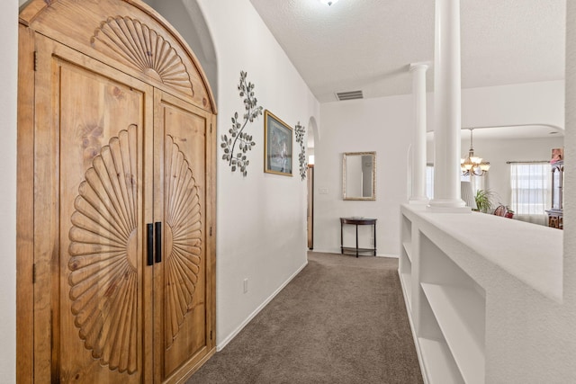 1908 Selway Pl NW, Albuquerque, NM 87120 - hall with carpet floors, decorative columns, baseboards, arched walkways, and a chandelier