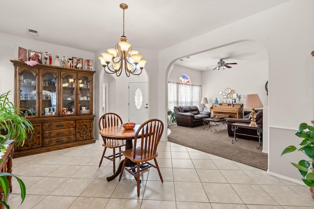 1908 Selway Pl NW, Albuquerque, NM 87120 - dining area featuring arched walkways, light carpet, a ceiling fan, light tile patterned flooring, and a chandelier