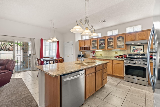 1908 Selway Pl NW, Albuquerque, NM 87120 - kitchen with appliances with stainless steel finishes, a sink, light tile patterned flooring, under cabinet range hood, and backsplash