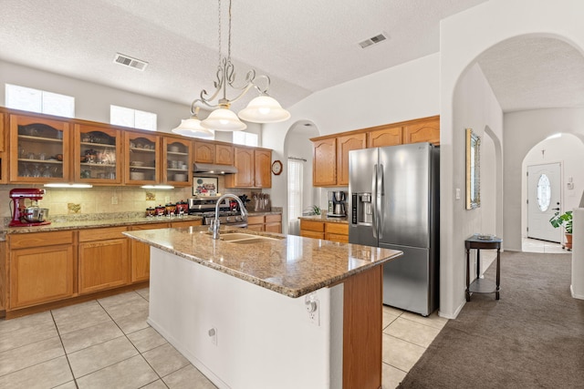 1908 Selway Pl NW, Albuquerque, NM 87120 - kitchen with stainless steel refrigerator with ice dispenser, arched walkways, a sink, light tile patterned flooring, and a textured ceiling