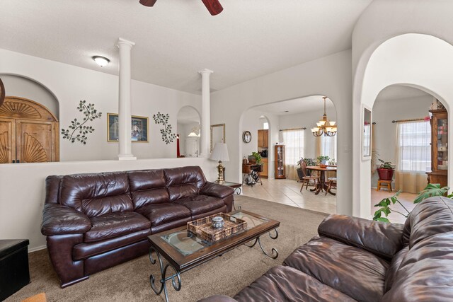 1908 Selway Pl NW, Albuquerque, NM 87120 - carpeted living room featuring arched walkways, ornate columns, ceiling fan, and a chandelier